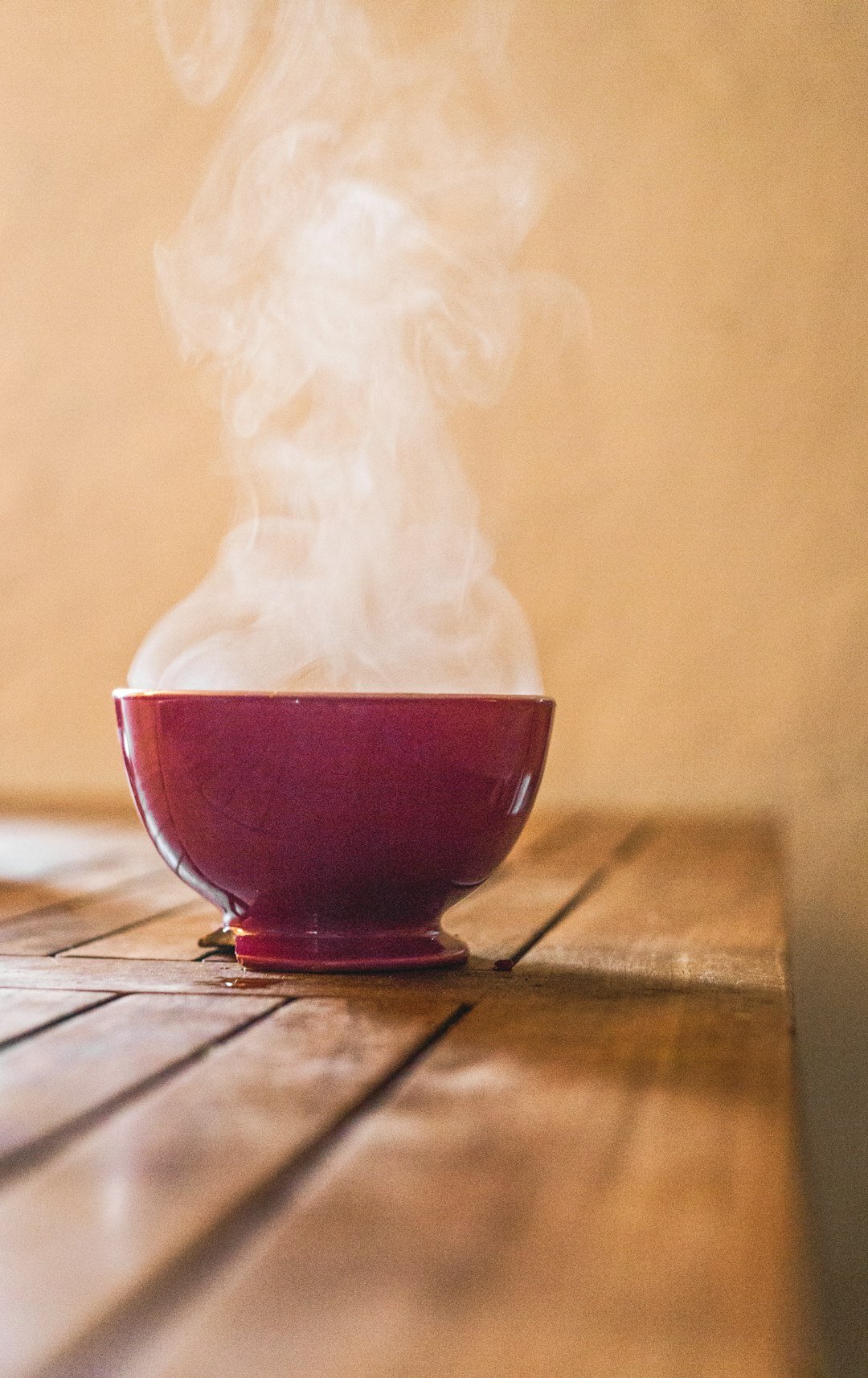 Steaming bowl of hearty winter soup on a table